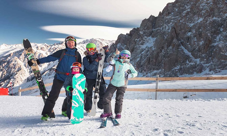 Happy family skiing in the mountains